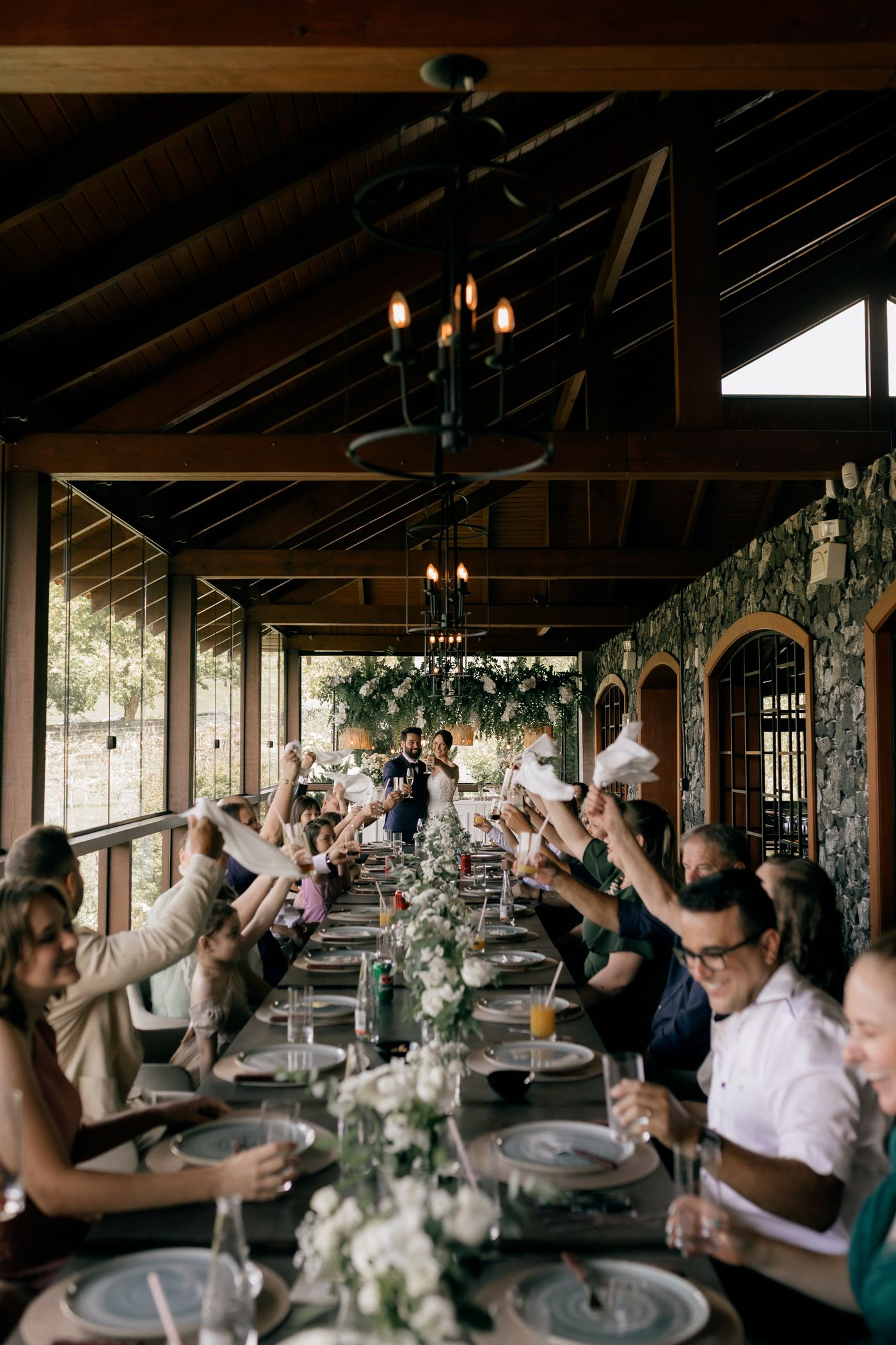 Guests seated at a long reception table during an event.