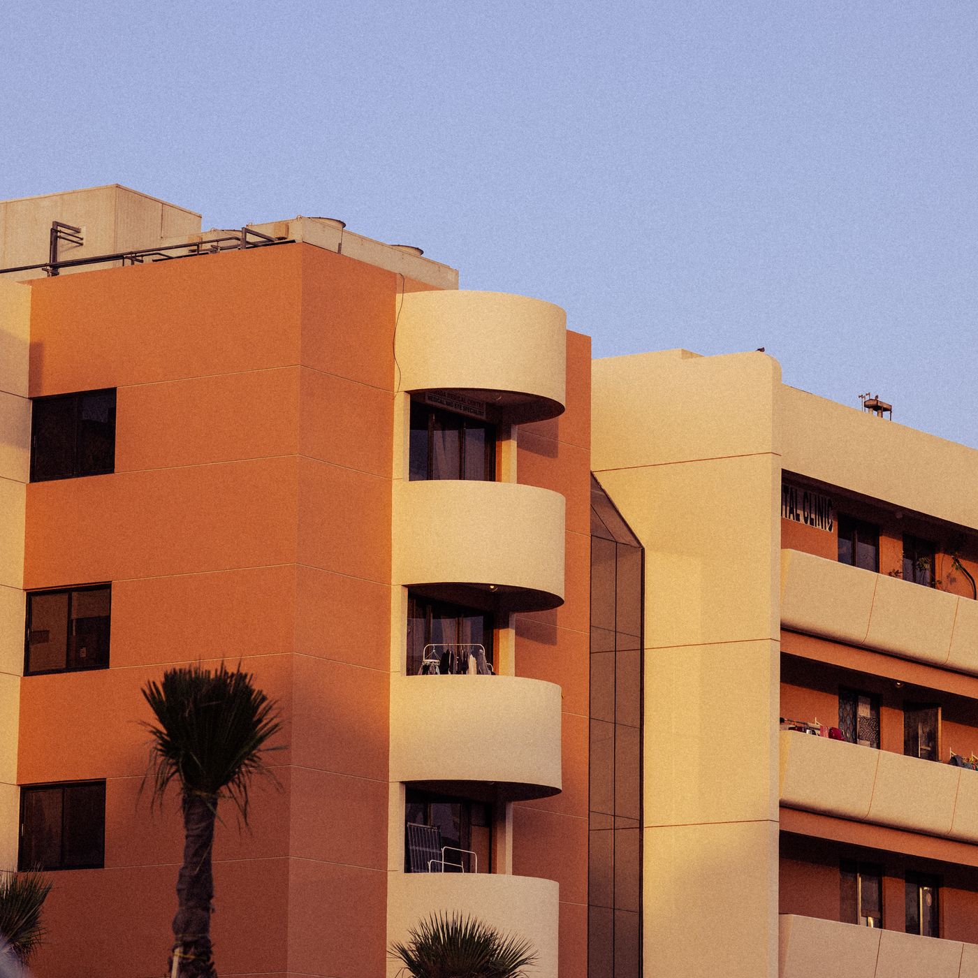 Exterior of an apartment building with balconies.